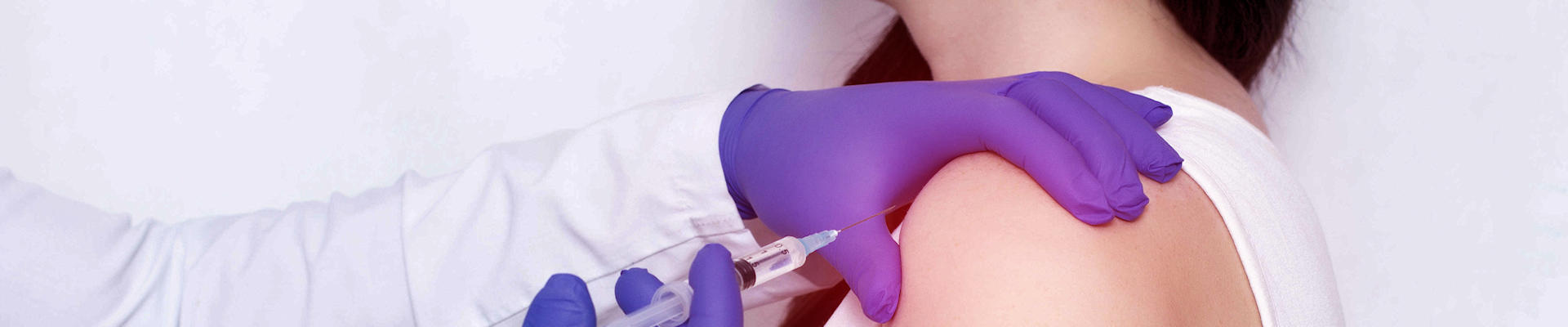 Someone being given injection in shoulder